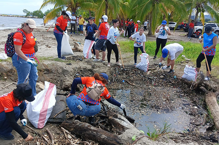 2024 EUBeachCleanup in Honduras, people on a beach picking up rubbish