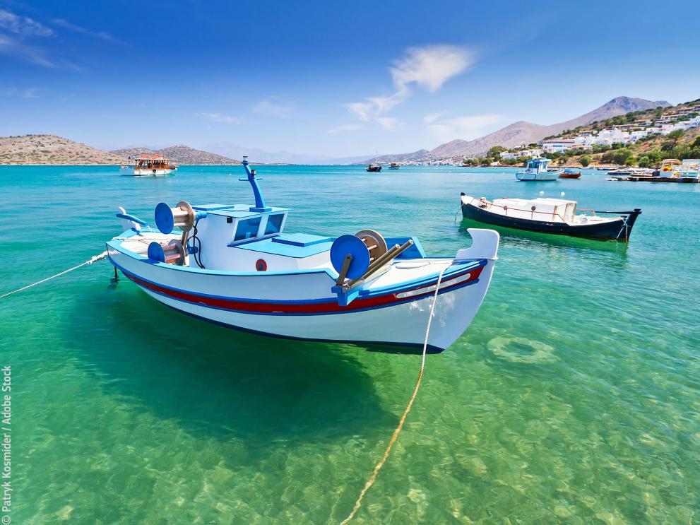 Fishing boats at the coast of Crete, Greece © Patryk Kosmider / Adobe Stock