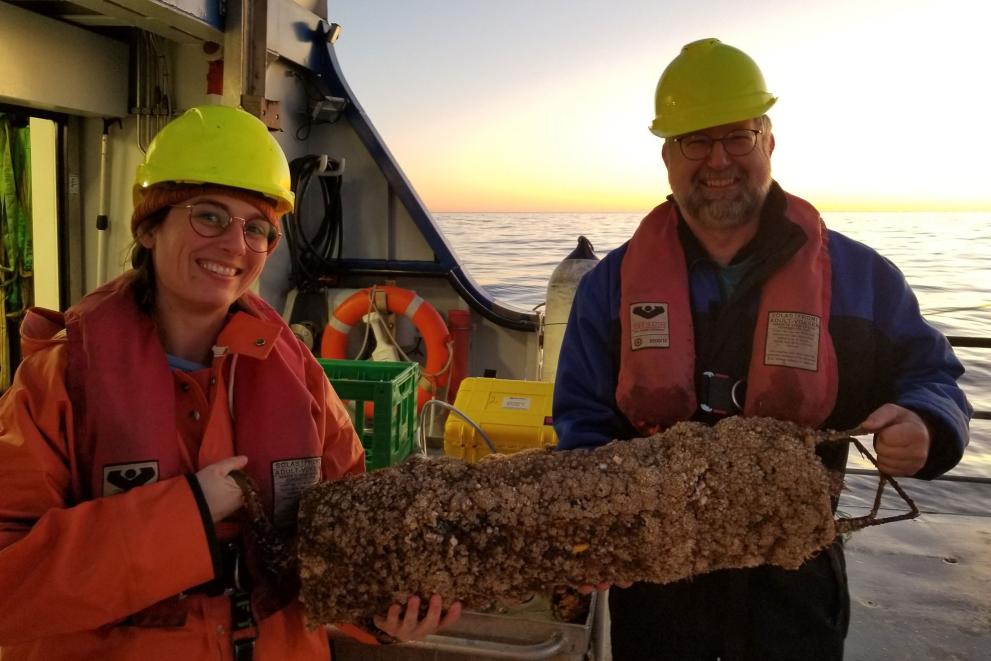 Emily T. Griffiths and Jacob Tougaard, Aarhus University, on board the research vessel Aurora, holding one of the recording devices used for the monitoring.©Ecoscience, Aarhus University, 2021